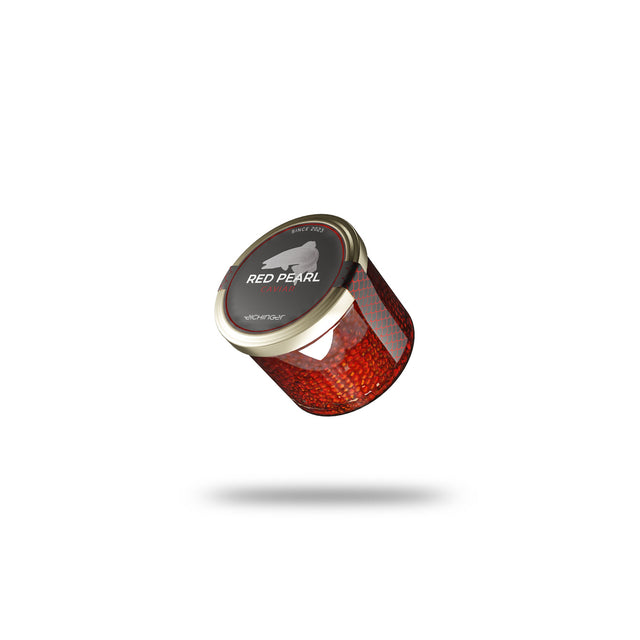A glass of Red Pearl Trout Caviar full of vibrant red caviar pearls