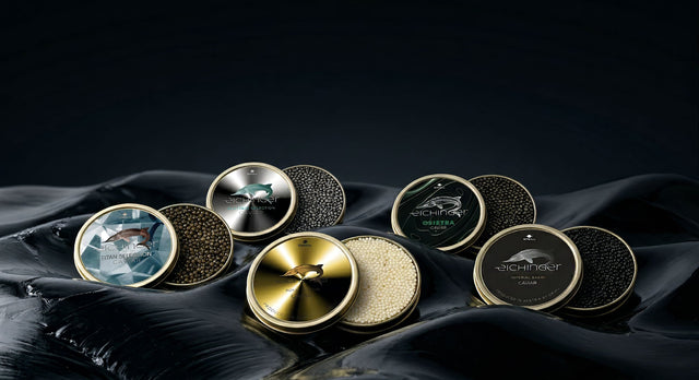 Luxury Austrian Caviar by Eichinger – Imperial Baerii, Osietra, Royal Albino and limited Titan & Platinum Selection displayed in open tins on abstract dark background