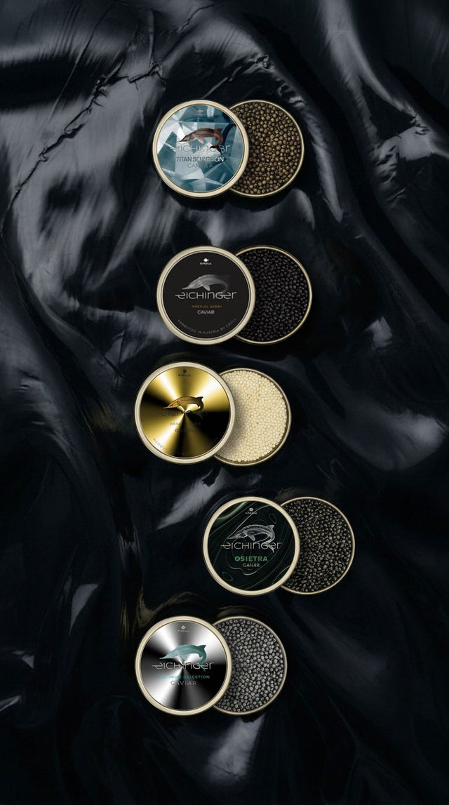 Luxury Austrian Caviar by Eichinger – Imperial Baerii, Osietra, Royal Albino and limited Titan & Platinum Selection displayed in open tins on abstract dark background